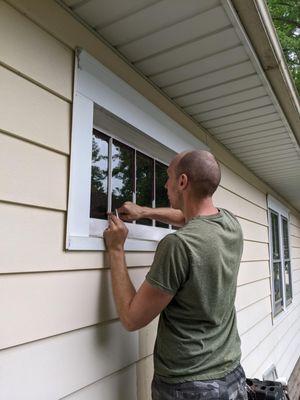 Applying new glazing putty to original wood windows on a home in south Minneapolis.