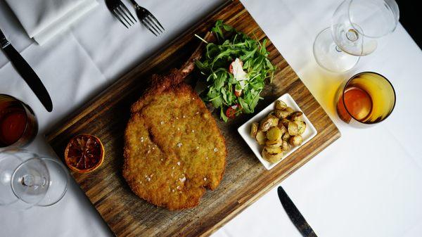 Veal Milanese with breaded veal piccata, arugula & cherry tomatoes salad, shaved parmigiano