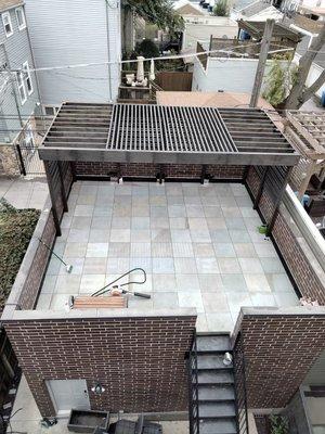 Porcelain pedestal deck and stained cedar pergola