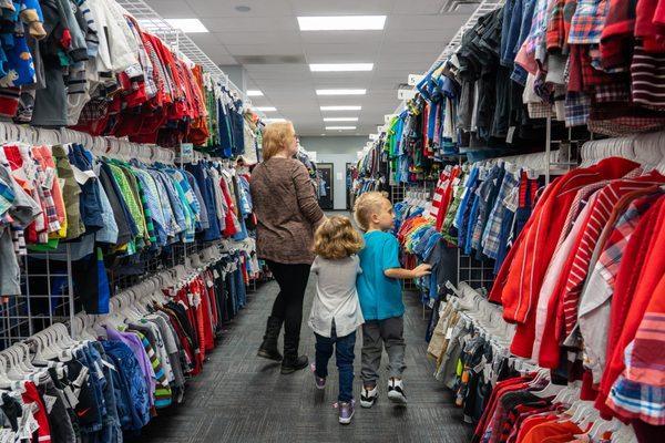 Mom,  schood age son, preschool daughter shopping.