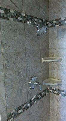 Shower tile with glass accent strip.