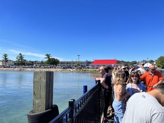 People lined up the entire length of the pier and all the way through the parking lot.