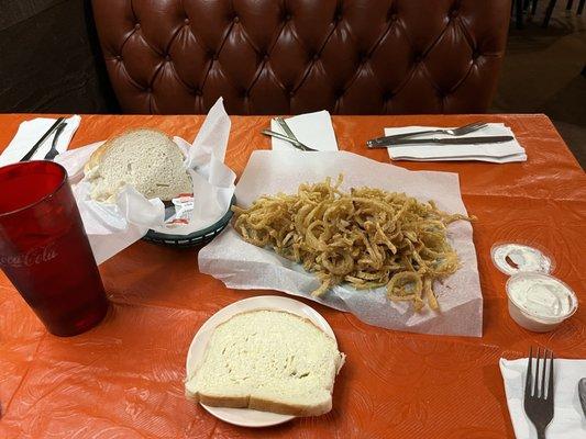 Homemade bread brought table side with butter, small order onion rings, homemade ranch, sweet tea