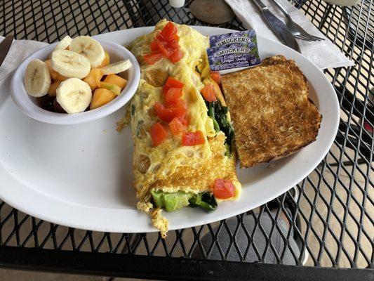 Veggies omelet with fruit and toast