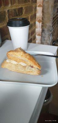 Delicious drip coffee with an excuisite strawberry and cream puff pastry.