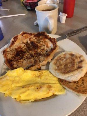 Pork chop and eggs with an English muffin