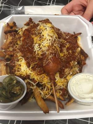 Chili cheese fries topped with a chili cheese corn dog