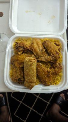 Fried rice with chicken wings and a egg roll