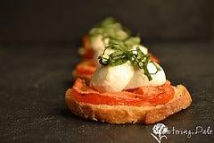 Tomato mozzarella basil crostini