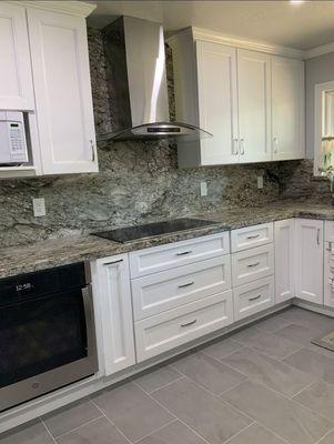 Total kitchen remodel.  Stone slabs for counter and blacksplash and tile floor.