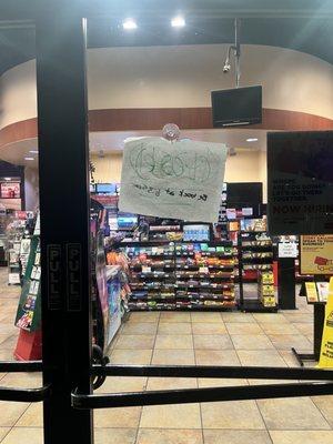 Barely legible make shift "closed" sign, for a store that's supposed to be 24/7...