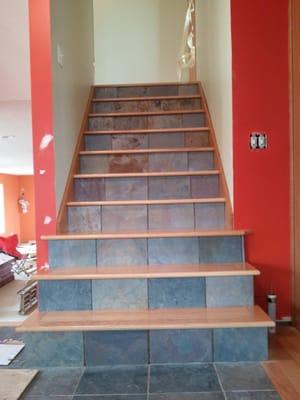 Custom staircase installation. Slate tile installed on the risers and solid hardwood installed for treads.