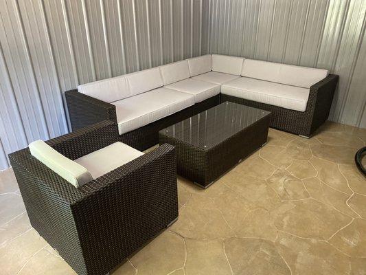 Outdoor furniture from our Cambridge Collection. Black rattan with gray cushions.