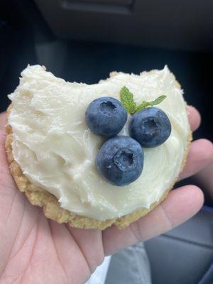 Sugar cookie with a cream cheese frosting and blueberries