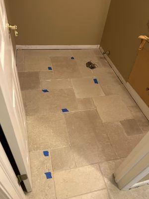 Powder room-blue tape is unlevel tiles