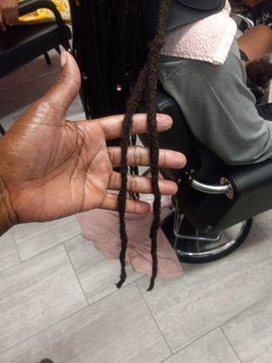 Loc repair.  Two locs attached years ago leaving a tail now turned into one solid loc.