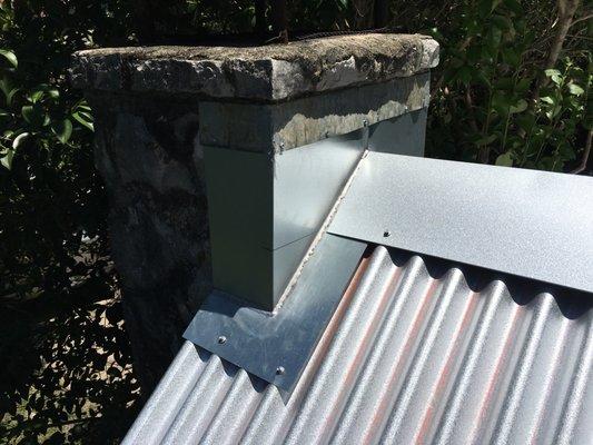 Custom made chimney flashing on a house from the 1870s, on which we replaced the roof with beautiful new metal roofing.