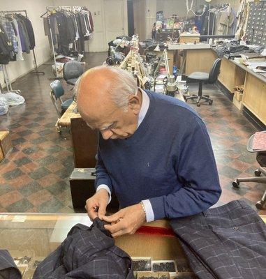 Tailor Sunder checks how much extra material within my jacket cuffs and inseams he has to lengthen my suit.