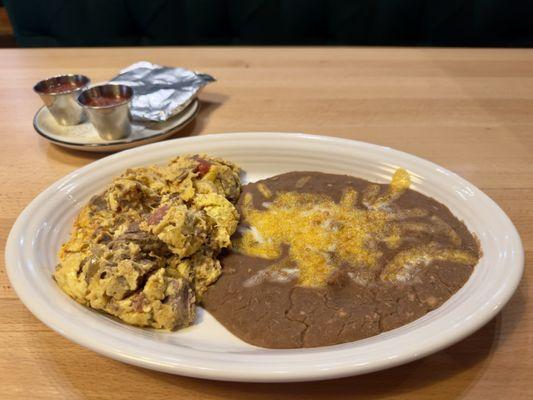 Machaca and Eggs - Shredded beef, tomato,  onions, bell peppers served with salsa and corn or flour tortillas.