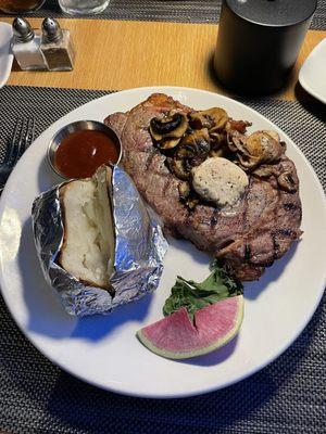 Small Ribeye with baked potato.