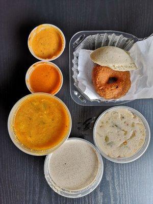 Upma (semolina with spices and veggies), idli ( rice cake), medu vada (fried lentil donut) with sauces and lentil soup