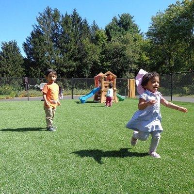 Children are having fun on our new turf playground surface.