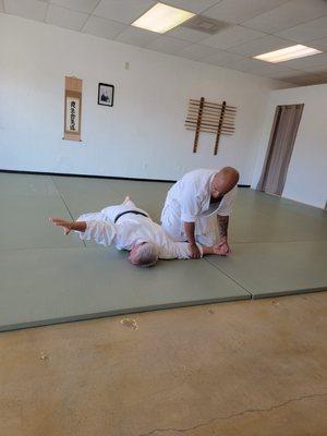 Sensei receiving a training technique.