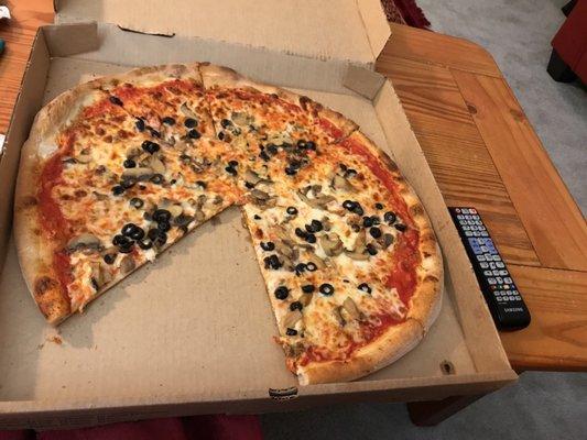 Large pizza with marinera sauce and toppings of olives and mushrooms.