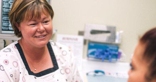 Hygienist, Shelley, chats with a patient.