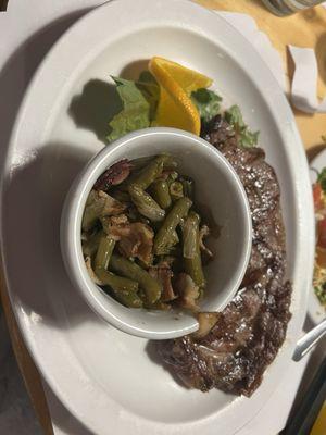 Rib eye with green beans and bacon.