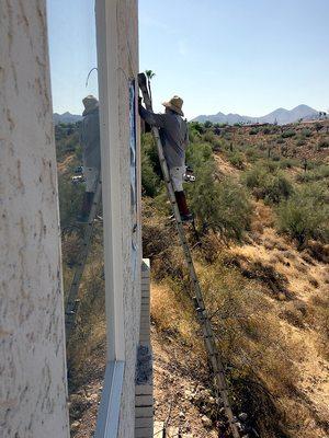 Valentine painting back of house in 109-degree afternoon