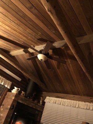 Vaulted ceiling with fan, can also see a bit of electric heat fireplace in corner