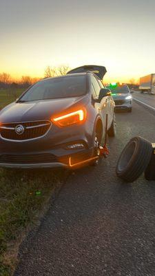 Tire change on side of the freeway. Dangerous work.