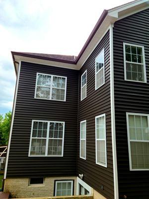 New Certainteed Monogram siding in Slate, crisp white soffit and fascia work and royal brown gutters & downspouts