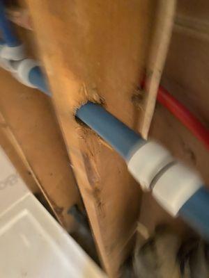 Pex in one of the studs. Should be a nail protector on that stud. This happened in at least 4 spots. Code violation.