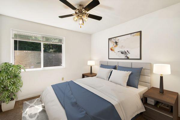 Bedroom with ceiling fan, large windows and taupe carpet.