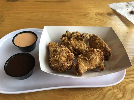 Delicious Korean fried chicken wings order of six (we ate two). The light orange sauce is the spicy mayo which is our favorite.