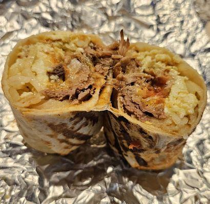 Inside the breakfast burrito with Uma pulled pork!