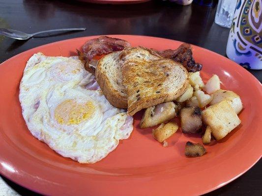 Eggs, wheat toast bacon, potatoes.