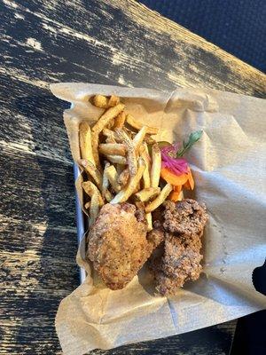 Two fried chicken breast with hand cut fries