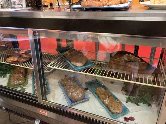 display case with croissants and cookies