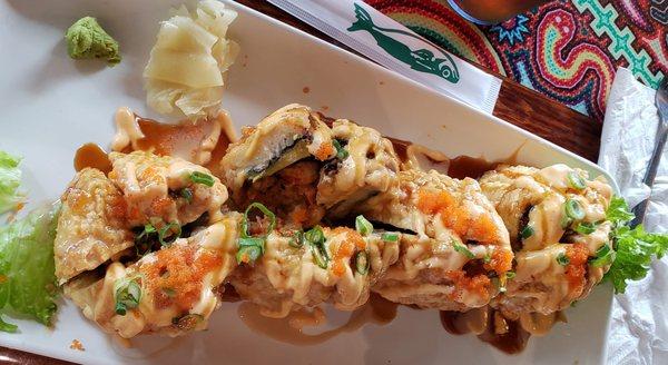 Mt. Rushmore Tempura Rolls =
 In: Crawfish, Avacado, Shrimp tempura & cream cheese.
 Top: Spicy mayo, EEL Sauce, Chives & fish eggs.