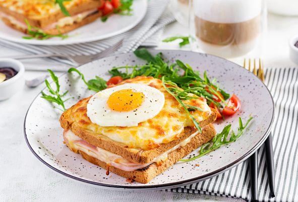 Croque Madame: (shredded gruyere cheese, ham, bechamel sauce, egg)