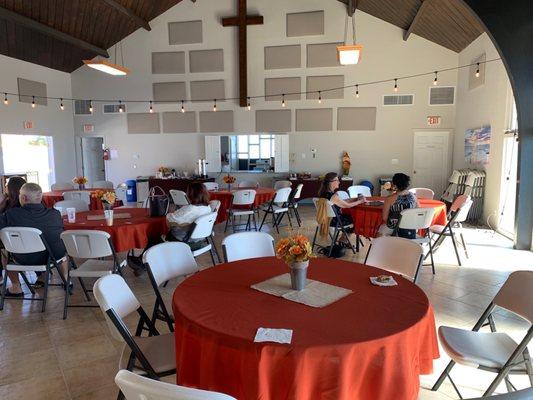 The interior of the fellowship hall. Below the cross is a large kitchen and the church provides coffee and pastries weekly for attendees.