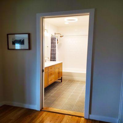 Phinney Ridge Bathroom Remodel.  Moved exterior wall to accommodate a larger vanity with 2 sinks and a floor to ceiling cabinet.