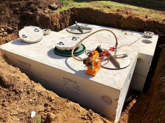 A pair of precast concrete septic and pump tanks are vacuum tested on-site in Hampton, NJ.