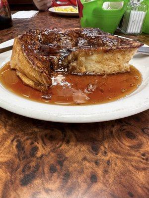 Side pic of French toast that is made with their own homemade bread and seasoned personally by the cook