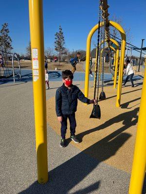 Need better protection for the passing by kids behind the swing.