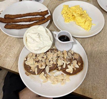 Silver Dollar Pancake (Pumpkin Spice with sliced almonds and whipped cream), with a side of Bacon N Eggs