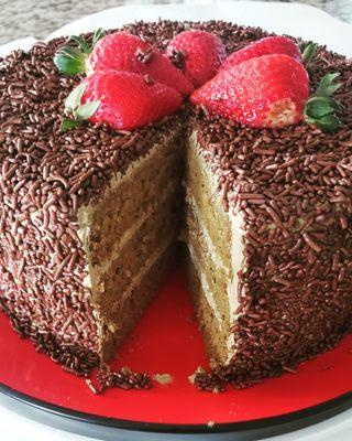 Coffee Mocha Cake with Mocha Buttercream filling, fresh strawberries and chocolate sprinkles.